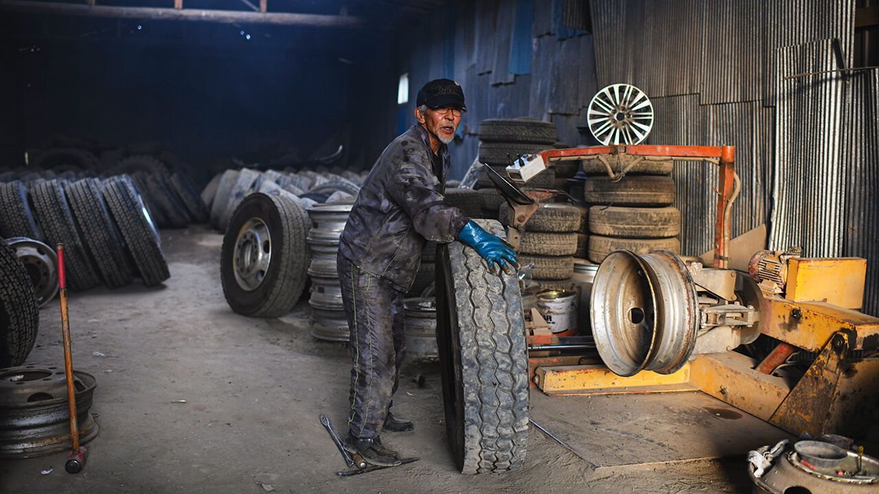 An older worker at a tyre company