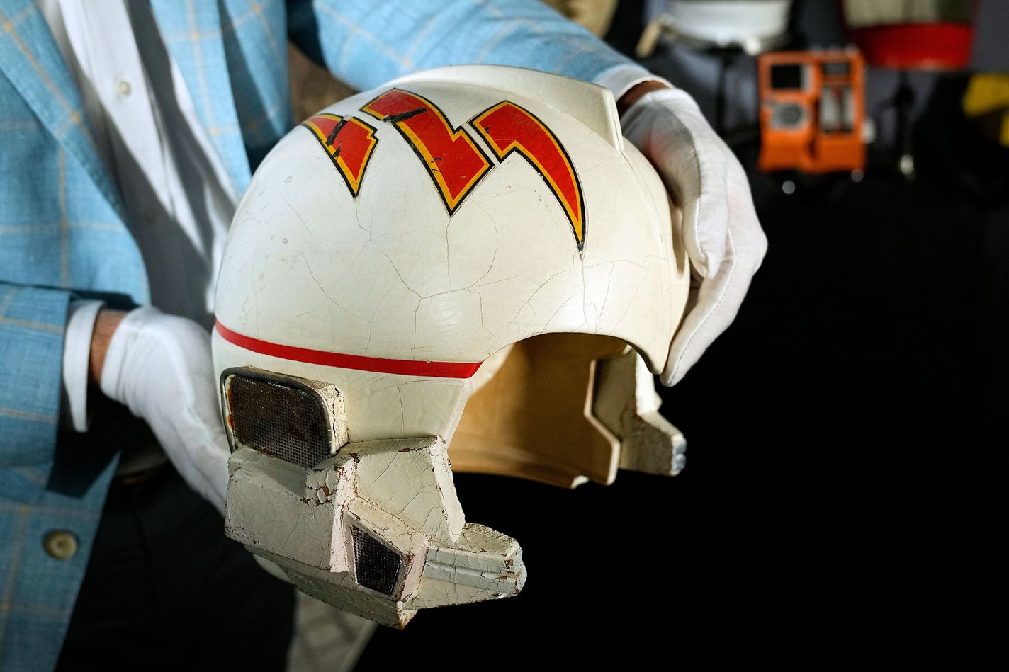 Heritage Auction's chief strategy officer, holds a prop starfighter pilot helmet used by actor Erin Gray who played, Col. Wilma Deering on the television series, "Buck Rogers"