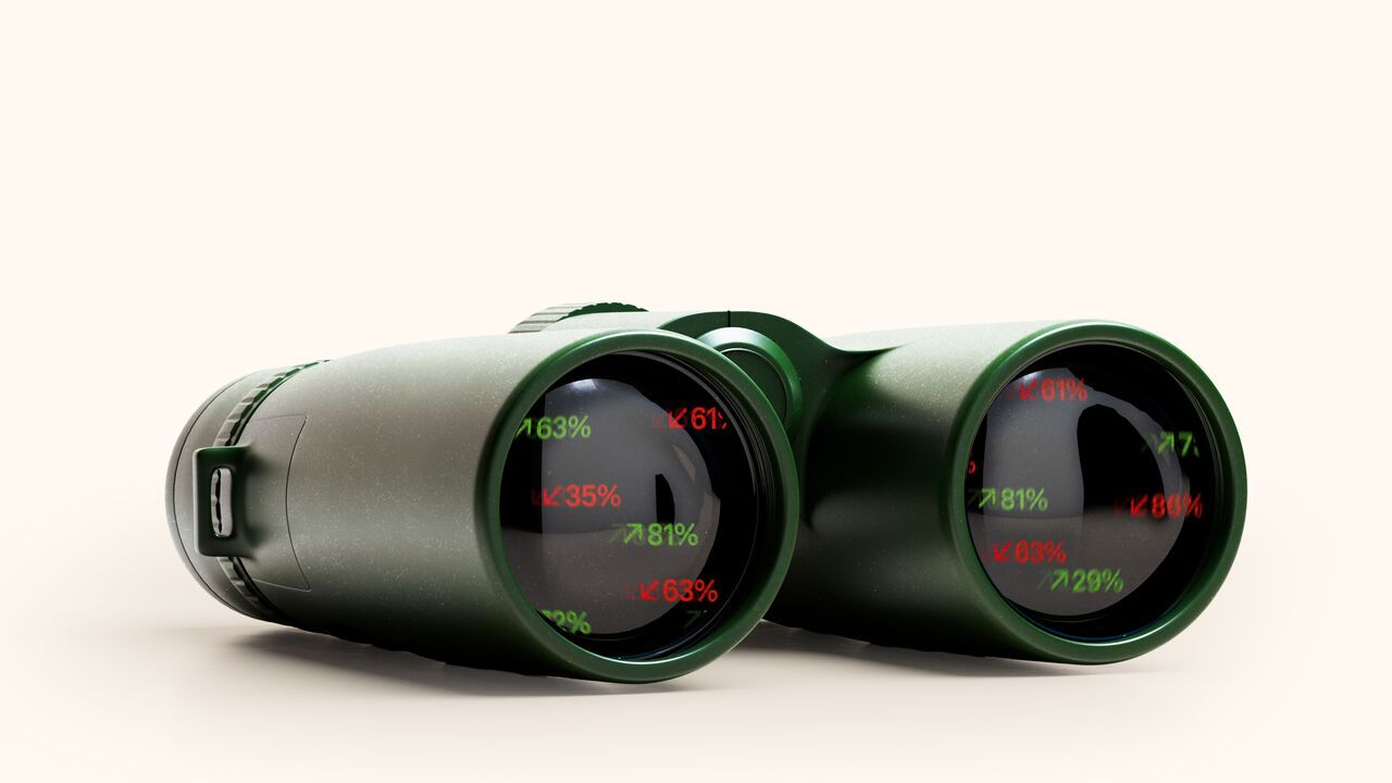 A photomontage of binoculars with percentages going up and down in the lenses.