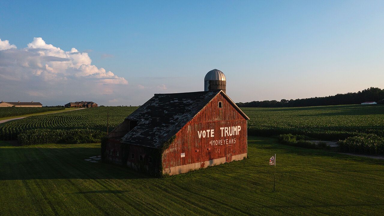 Aerial view of a barn on a farm that has 'Vote Trump' written on it.