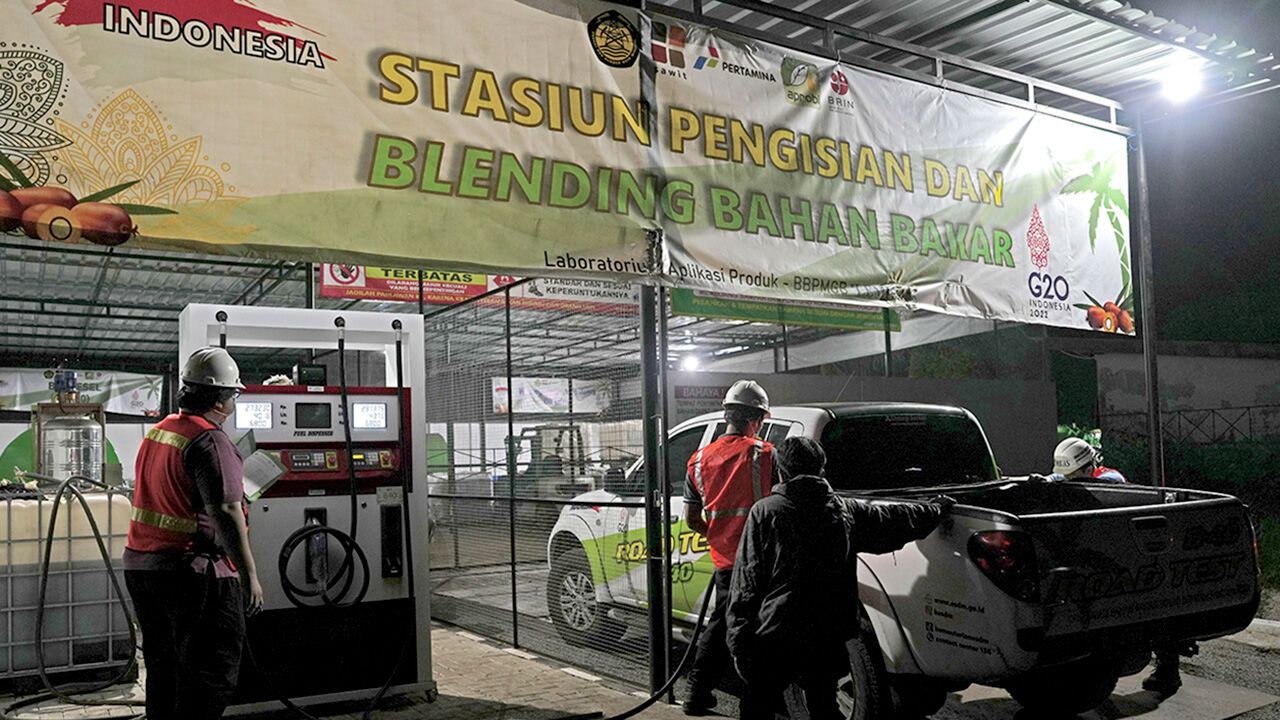 A worker refuels a vehicle during a road test of 40% palm-based biodiesel in Maribaya, West Java, Indonesia