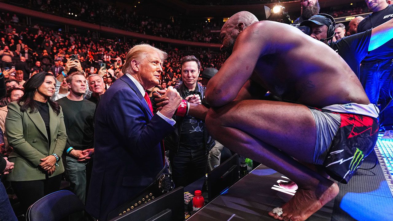 President-elect Donald Trump shakes hands with Jon Jones of the United States of America