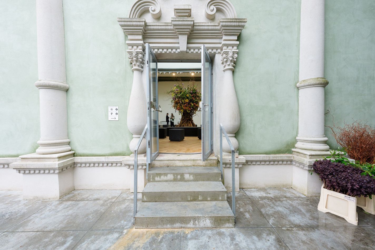 View of The Tree is rooted in the sky, through an open door at the pavillion of Russia