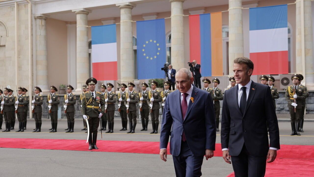 French President Emmanuel Macron, right, and Armenia's Prime Minister Nikol Pashinyan, second right, walk together during an official welcome ceremony for the EU-Armenia summit at the Presidential Palace in Yerevan, Armenia.
