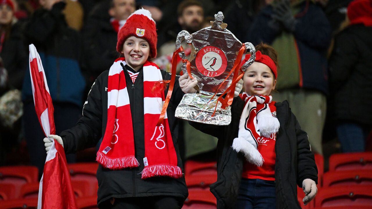Bristol City fans hold up a tin foil Emirates FA Cup trophy after the Emirates FA Cup Third Round Replay match between Bristol City and West Ham United.