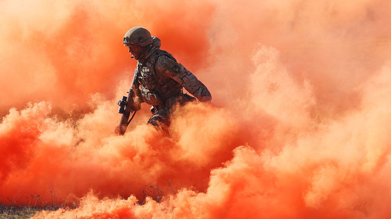 A soldier of the United Kingdom's 2nd Battalion Royal Anglian infantry unit storms an enemy position in a simulated attack during the NATO Brilliant Jump exercises.