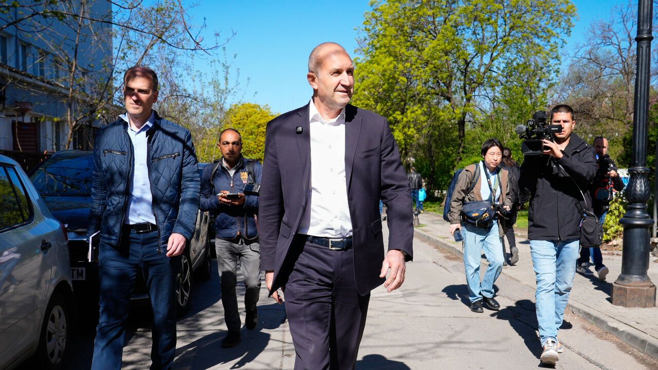 Rumen Radev is followed by members of the media after voting.