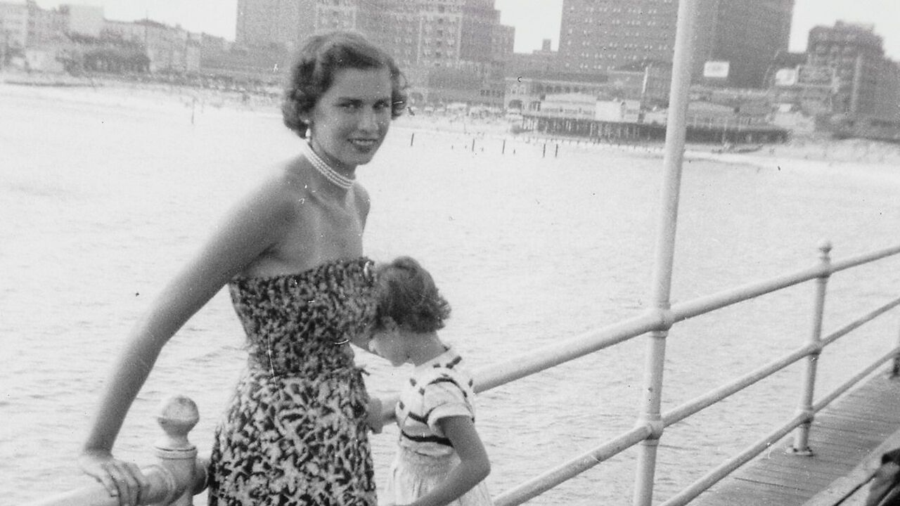 Dr Edith Eger when young, by the sea with a little girl