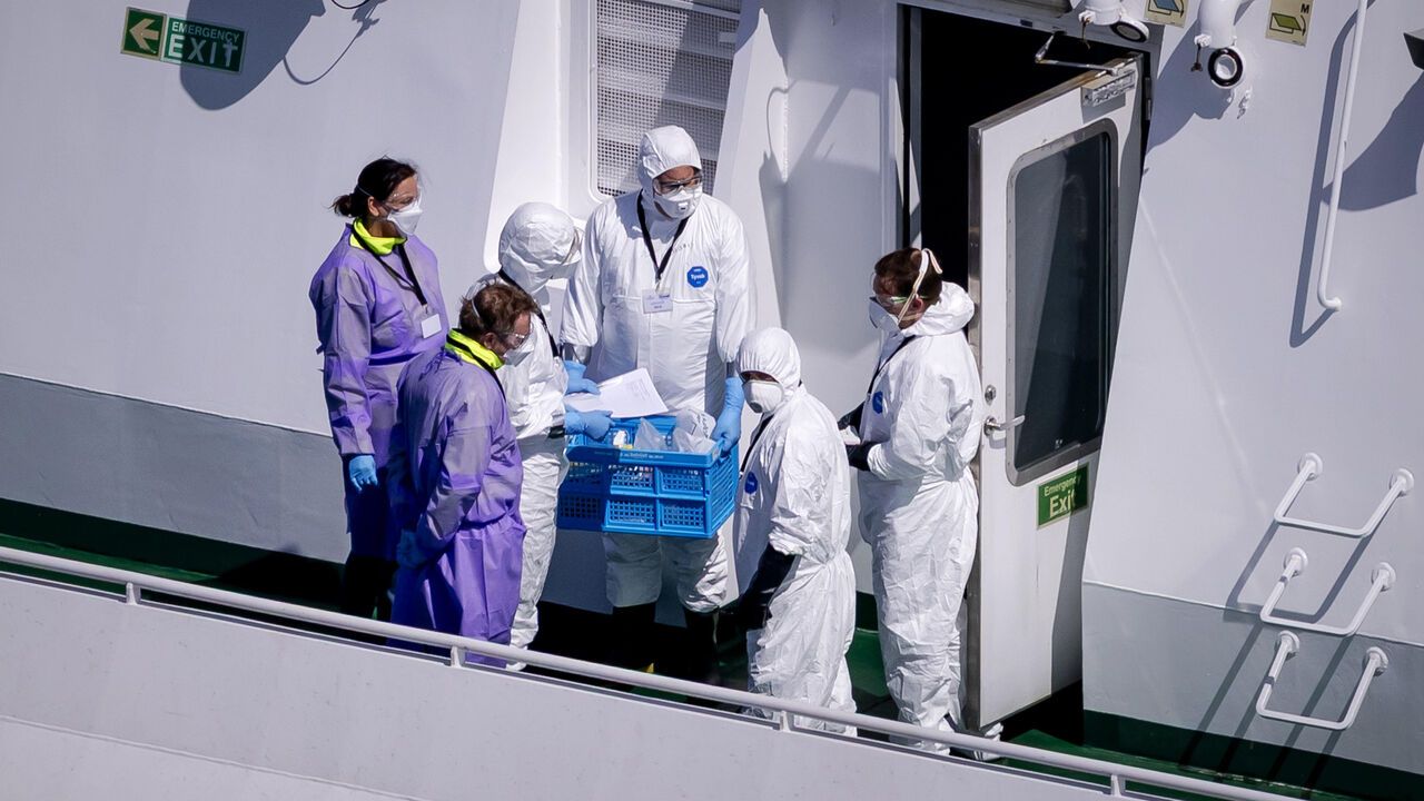 An aerial view of people in protective clothing on board the cruise ship MV Hondius.