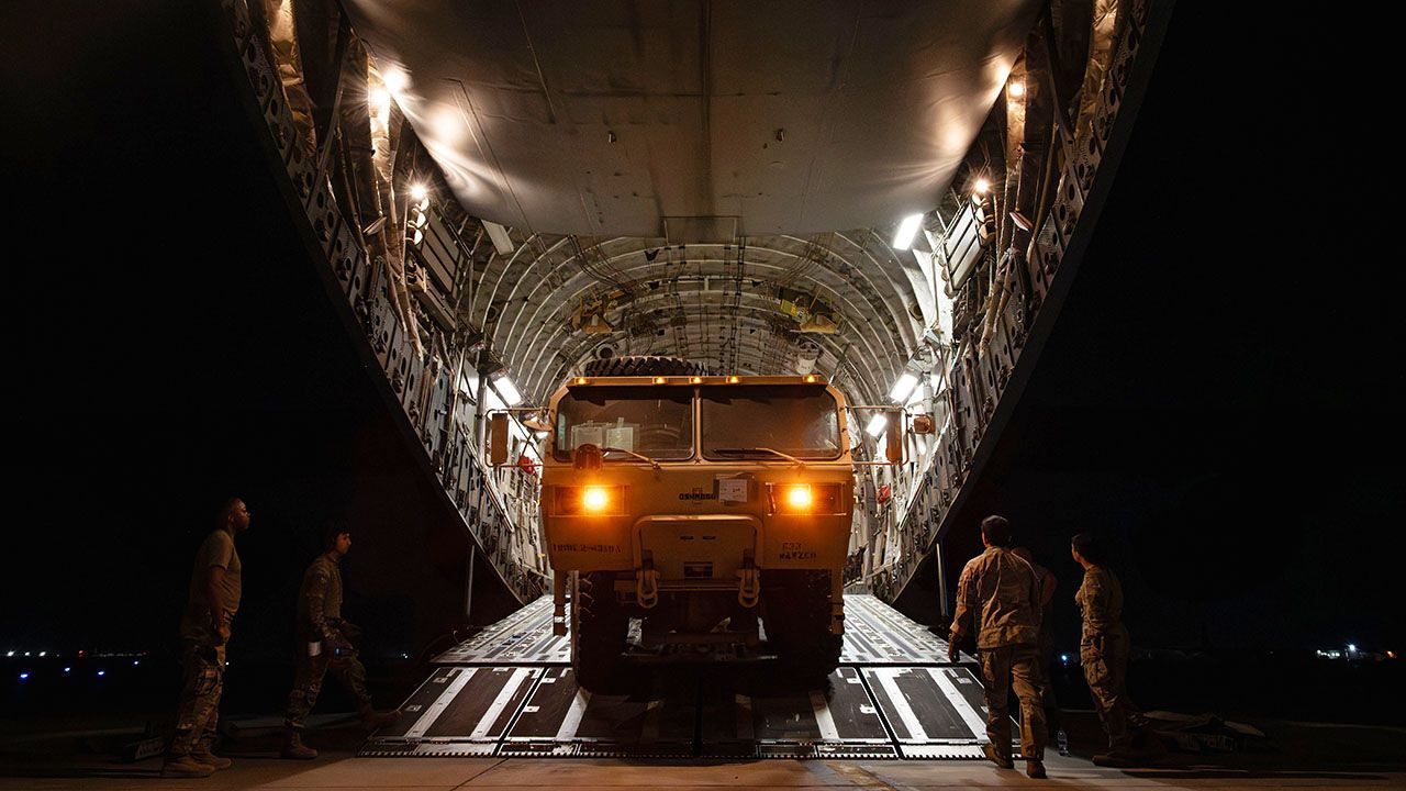 U.S. Air Force 380th Expeditionary Aerial Port Squadron personnel and 16th Expeditionary Airlift Squadron aircrew load a MIM-104 Patriot surface-to-air missile system onto a C-17 Globemaster III aircraft during a cargo mission.