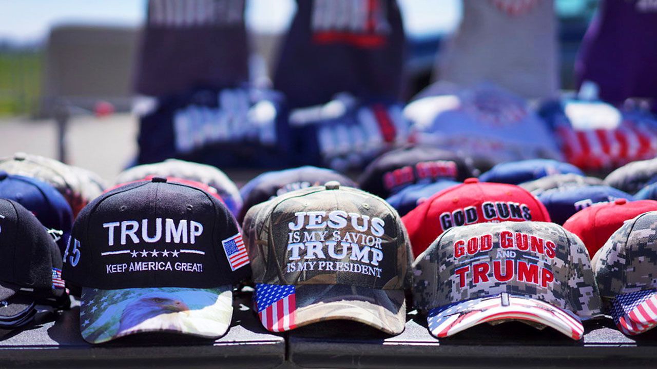 Hats reading "Jesus is my savior, Trump is my president".