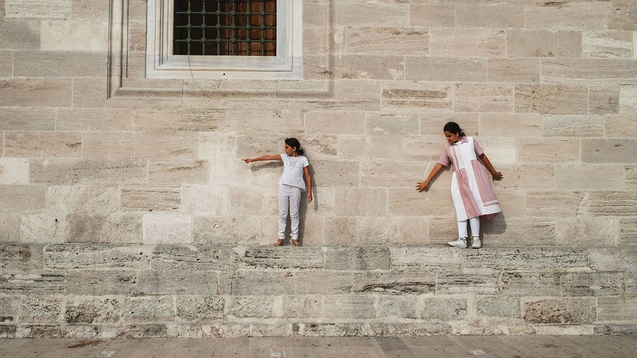 Children walk near a wall of a mosque in Istanbul's Fatih neighborhood, which has the highest percentage of Syrian population in the city.