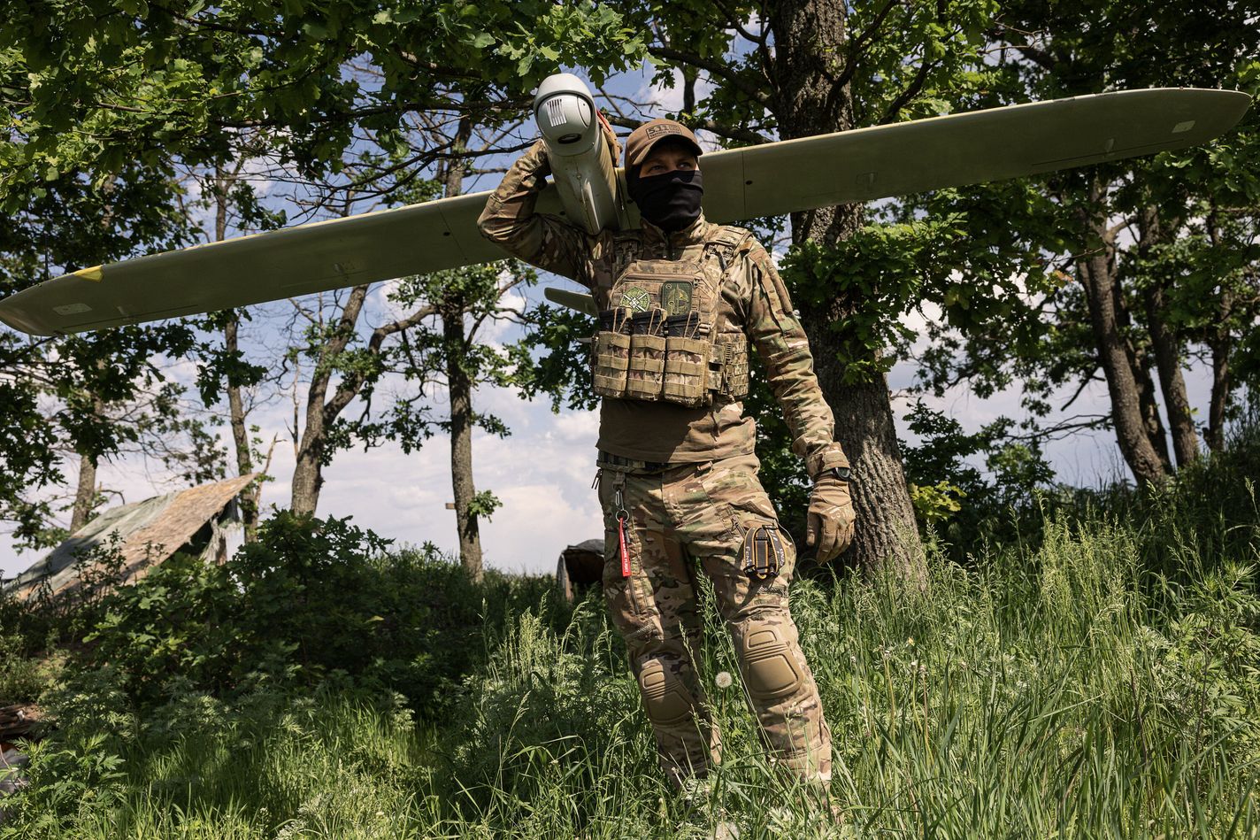 Member of the Lava Unmanned Systems Regiment poses for a photograph with a Leleka reconnaissance UAV in Ukraine.
