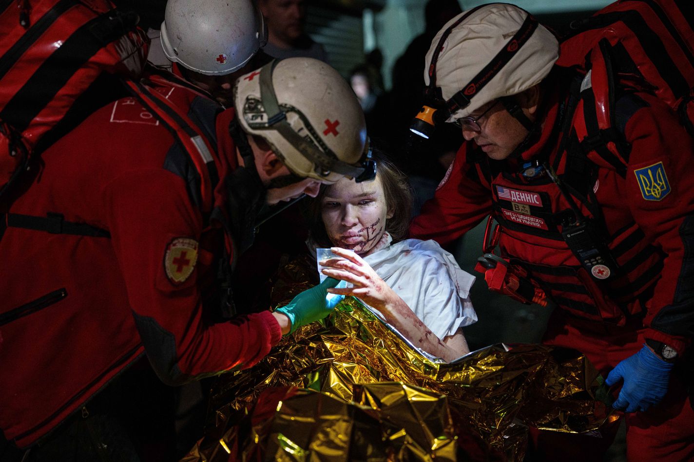 Red Cross volunteers help an injured woman in a shelter after a Russian strike on a residential neighborhood in Kyiv, Ukraine.