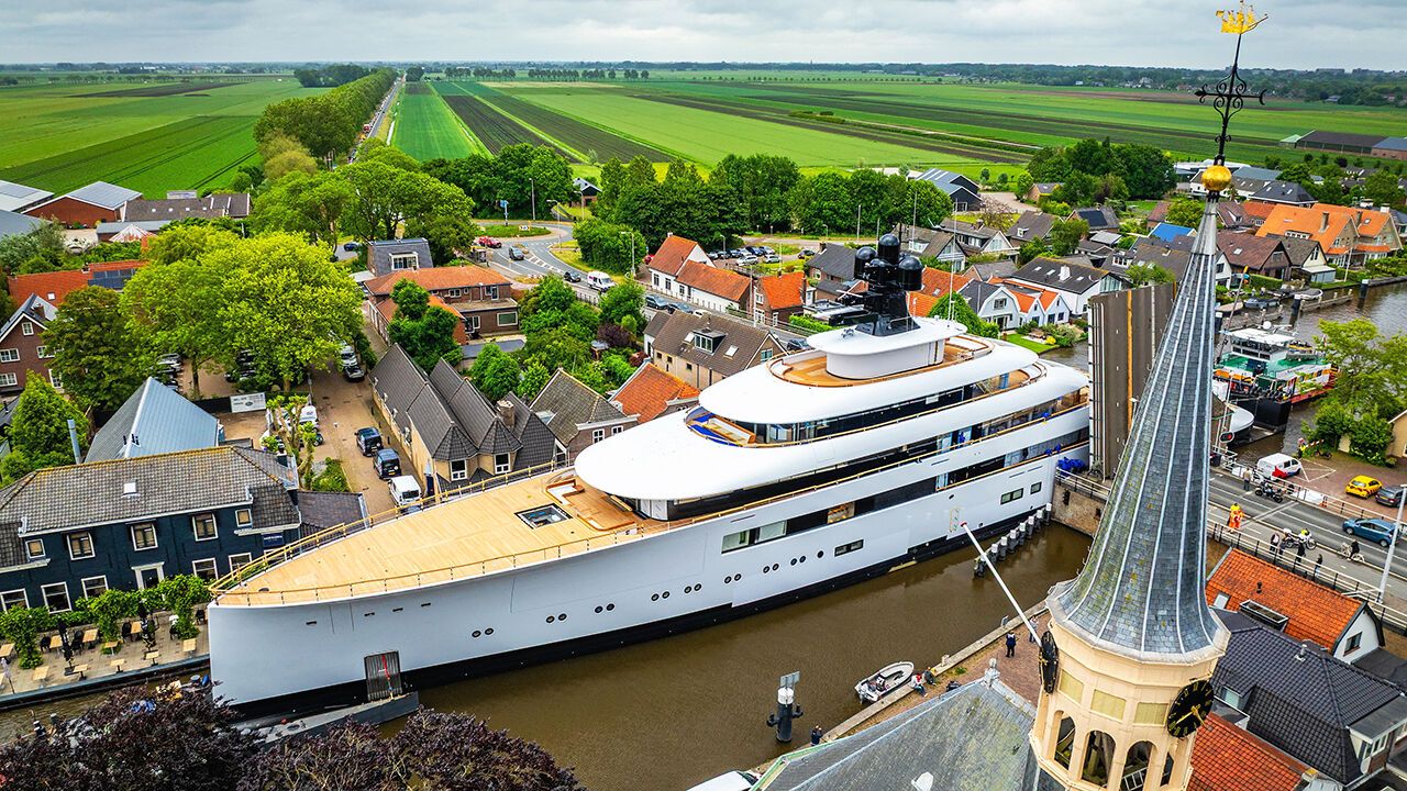 A mega yacht, built by Dutch yacht builder Van Lent for former Starbucks US CEO Howard Schultz, pasts a bridge in Woubrugge on its way to Rotterdam. 
