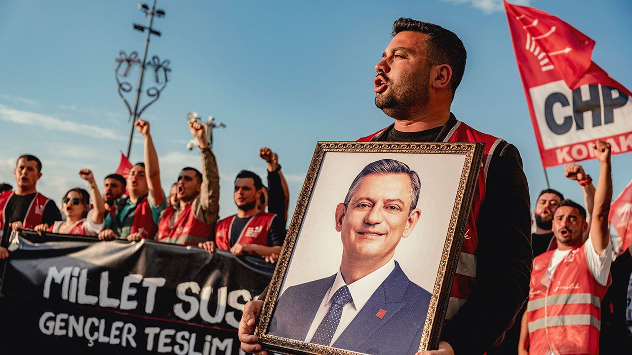Demonstrators carry a portrait of CHP leader Ozgur Ozel during a protest in Turkey.