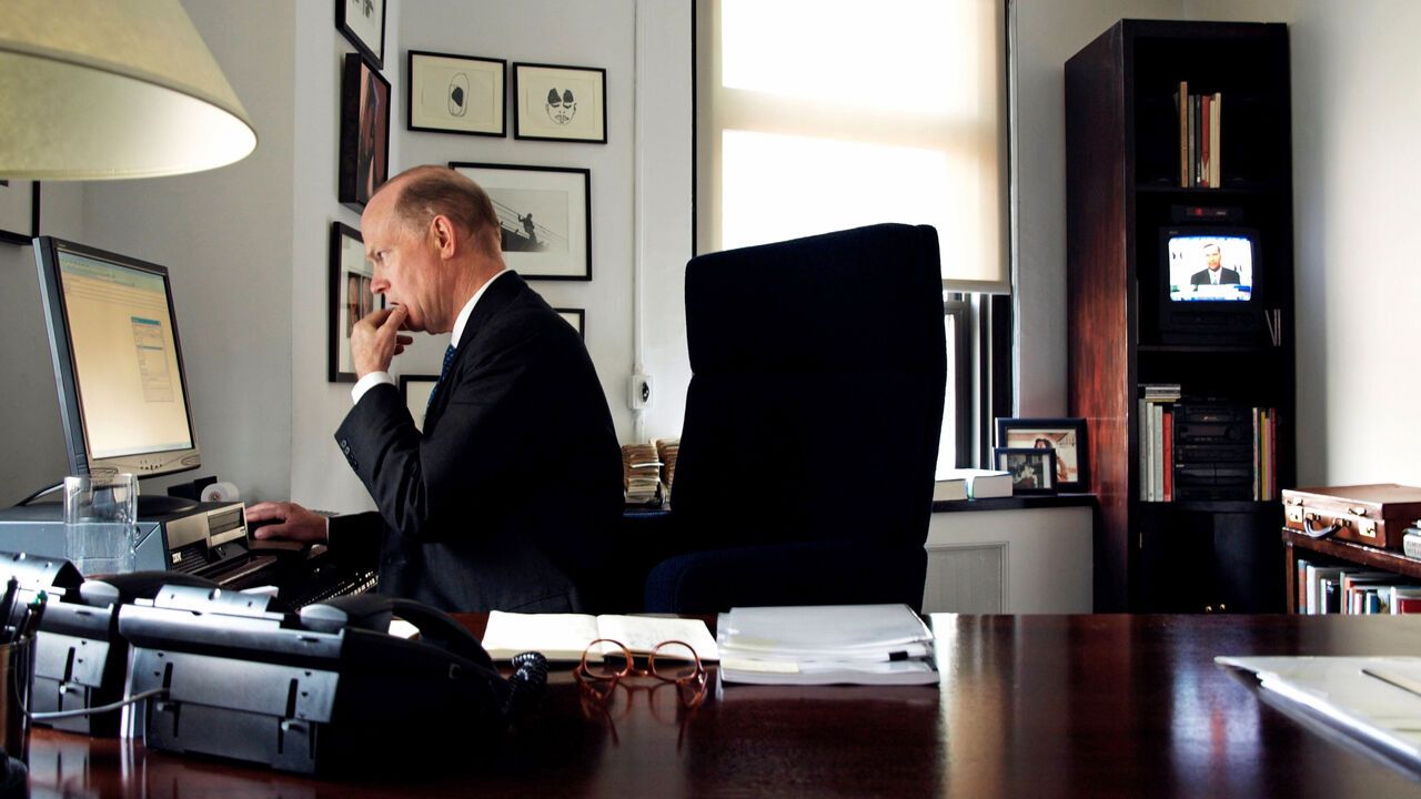 Literary agent Andrew Wylie sits at a desk in New York