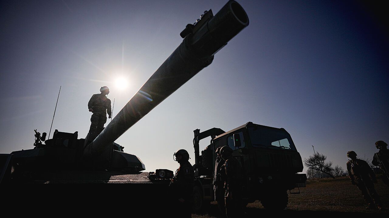 French serviceman stands on a Leclerc main battle tank during military exercises