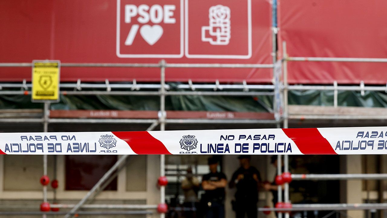 National Police officers stand outside the ruling Socialist Party headquarters in Madrid
