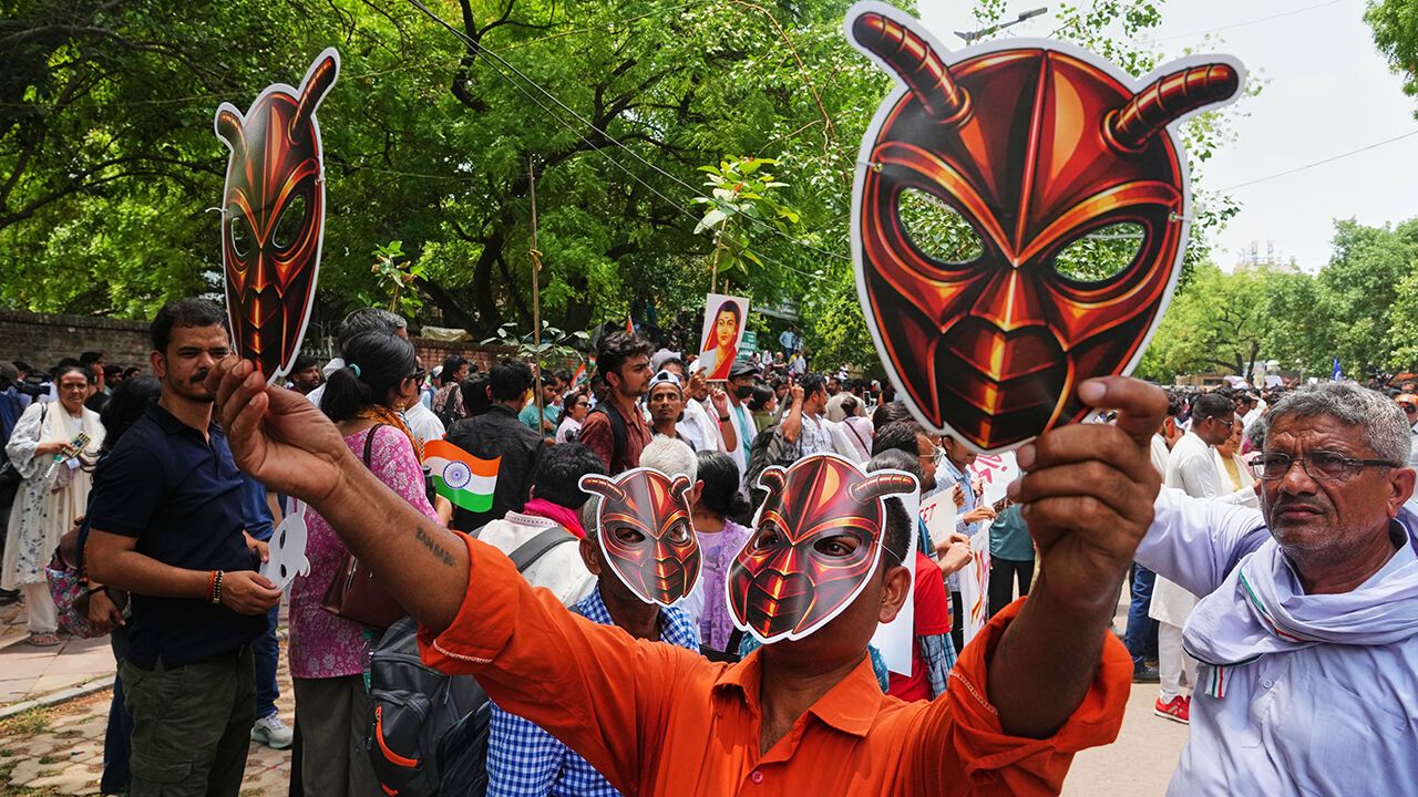 upporters of the Cockroach Janta Party wear and display masks during a protest demonstration in New Delhi, India, Saturday, June 6, 2026.
