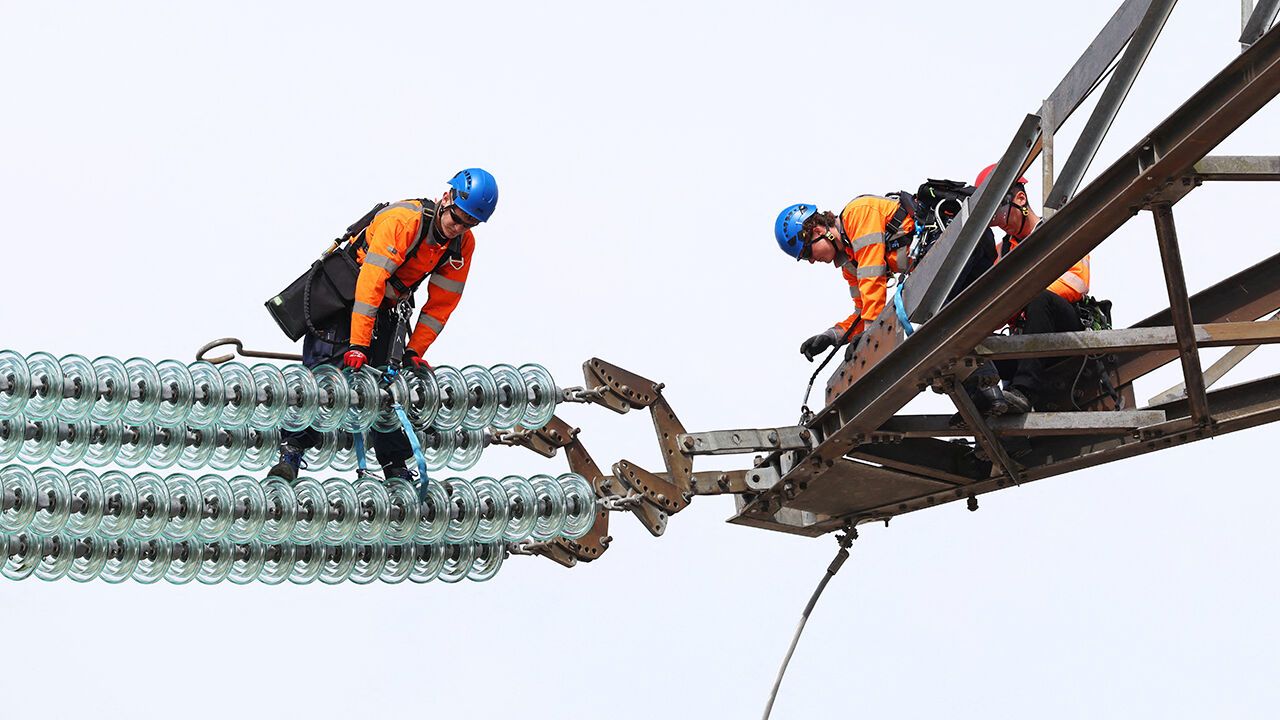 National Grid Overhead Line apprentices train on an electricity pylon at the National Grid training centre in Eakring, UK