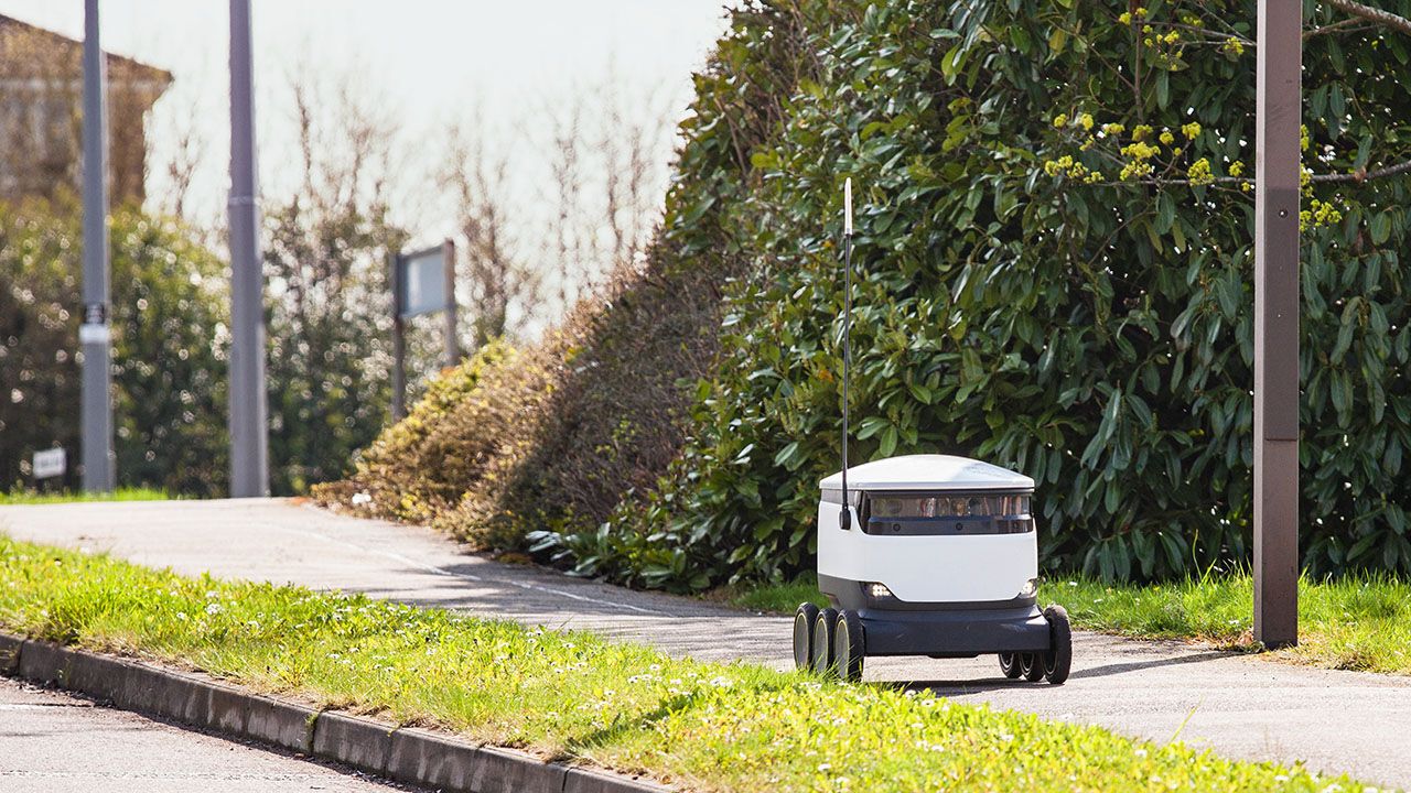 A starship robot driving down a pavement in Milton Keynes