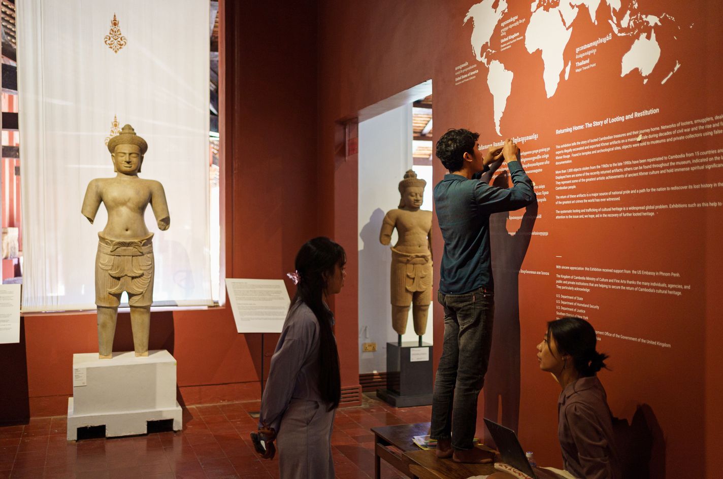 Workers apply the final touches to an exhibition titled “Returning Home,” which features some of the most significant Khmer stolen statues and artifacts repatriated to the National Museum in Phnom Penh