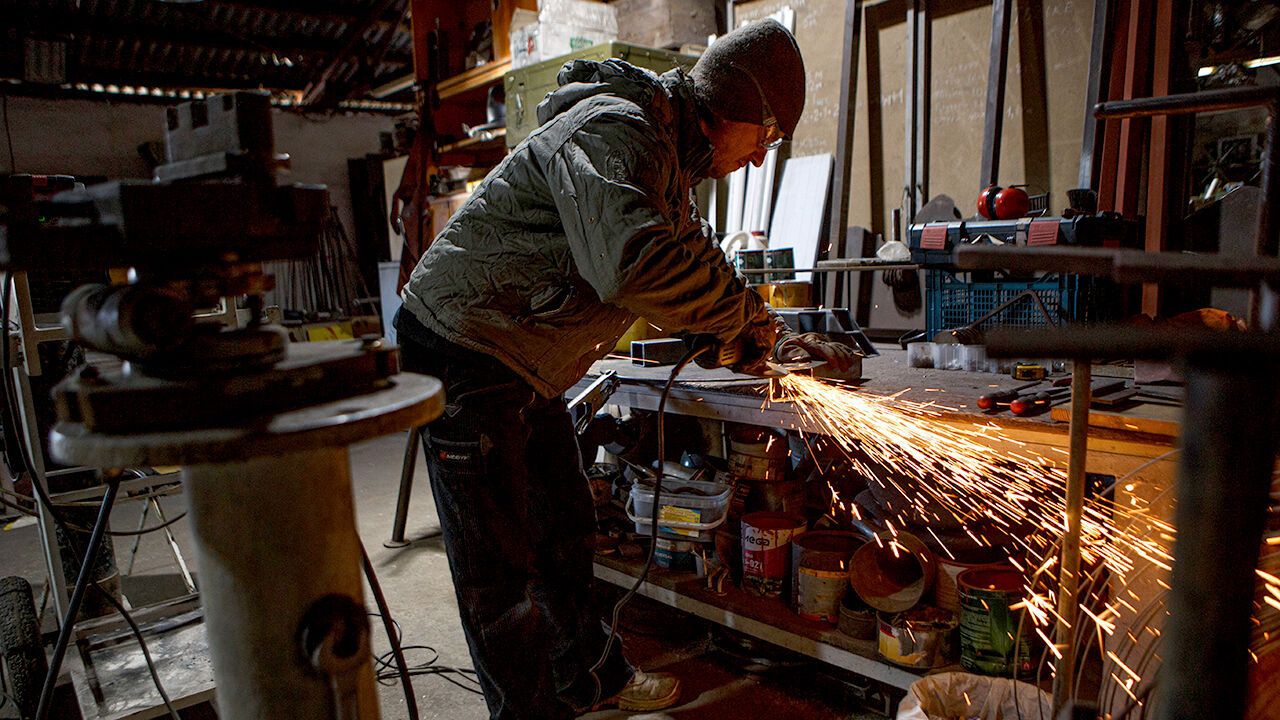 Metal workersworking at a workbench in their workshop in Perechyn, Ukraine in 2022
