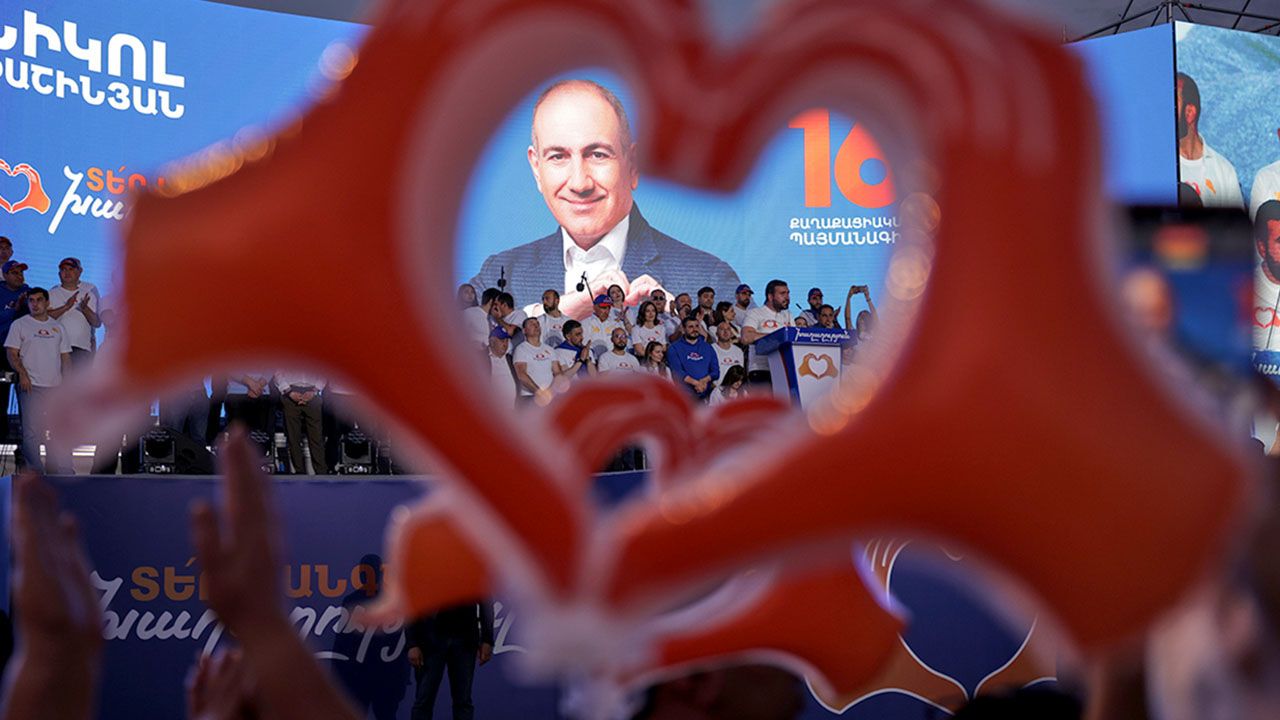 Supporters of Armenia's ruling Civil Contract party leading by Prime Minister Nikol Pashinyan hold up heart signs while gathering in Republic Square in Yerevan