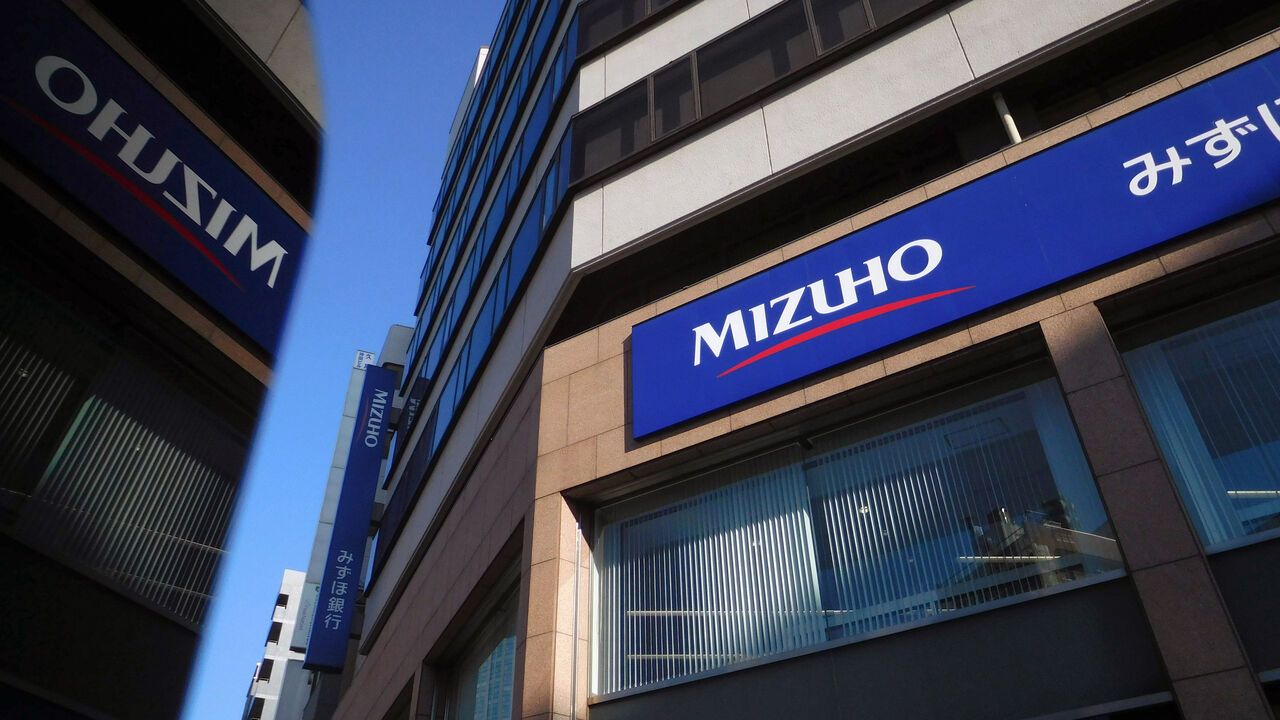 Signage for Mizuho Bank Ltd., a unit of Mizuho Financial Group Inc. (MHFG), at one of the bank's branches in Tokyo, Japan.
