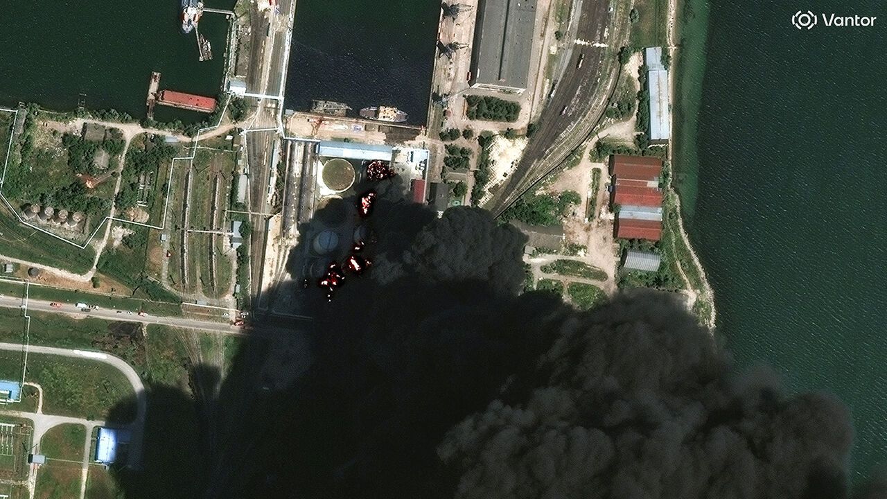A satellite image shows fire and smoke rising from oil tanks after a Russian drone attack