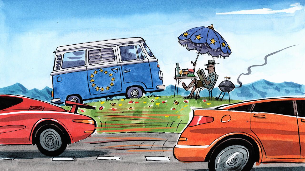 A man relaxing on the side of a budy road with a blue campervan with EU stars on the side