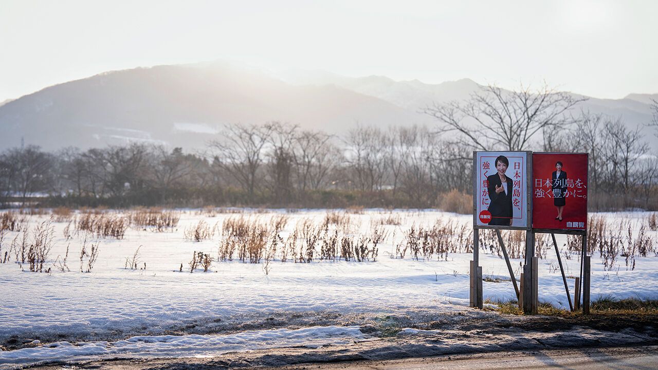 Liberal Democratic Party (LDP) poster boards featuring Japan's Prime Minister Sanae Takaichi stand in the snow in Date, Hokkaido prefecture in northern Japan on February 22, 2026.