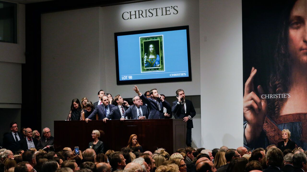 Agents speak on their phones with their clients while bidding on at the auction of Leonardo da Vinci's "Salvator Mundi".