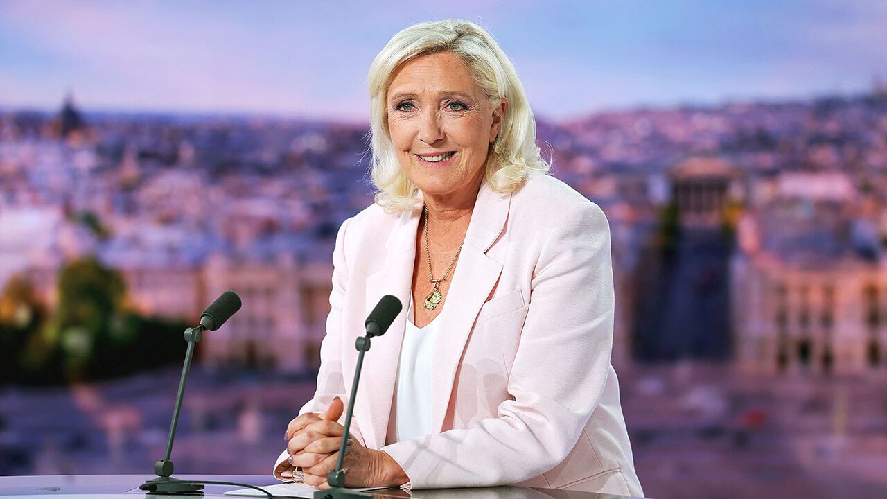 French far-right leader Le Pen reacts on TV after her appeal trial verdict.
