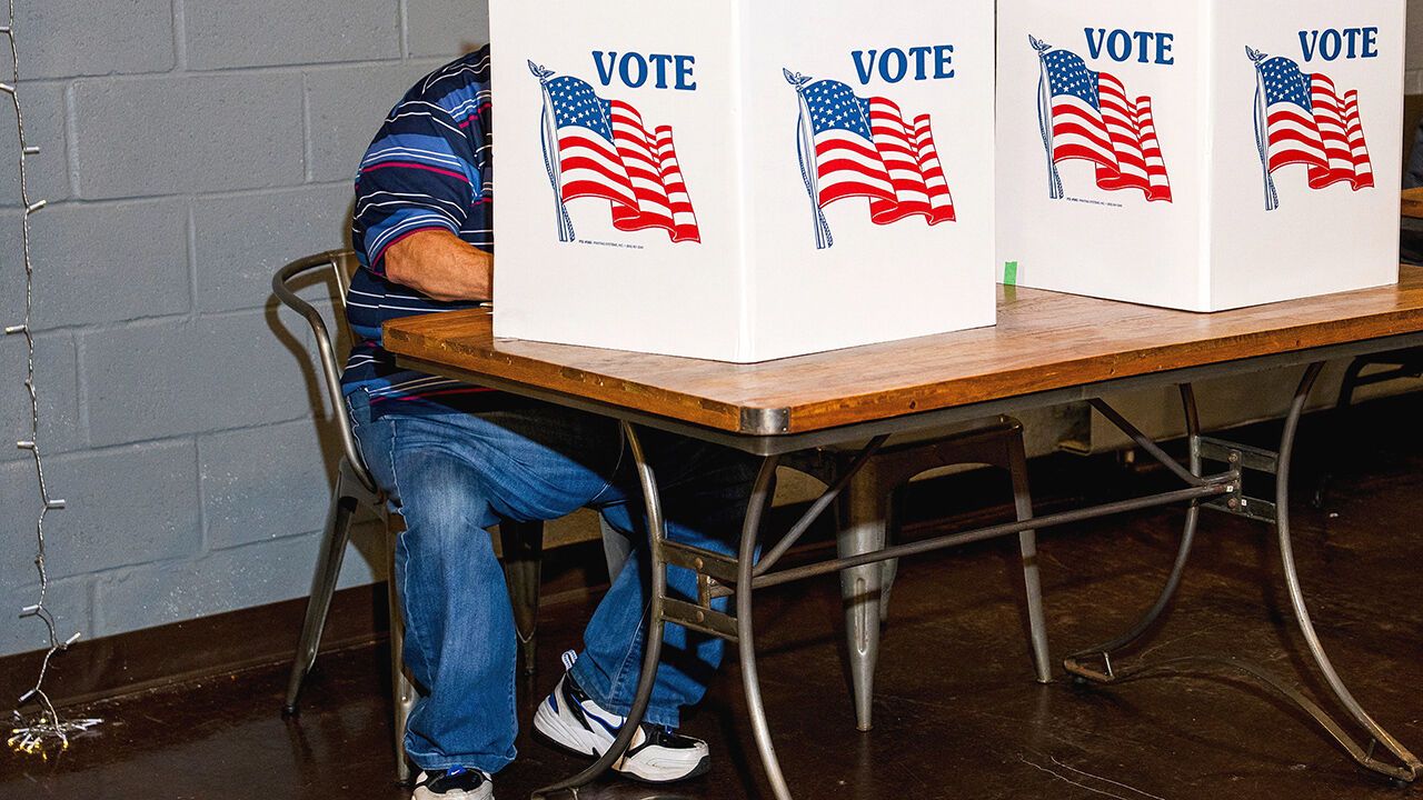 A voter fills out their ballot at a polling station.