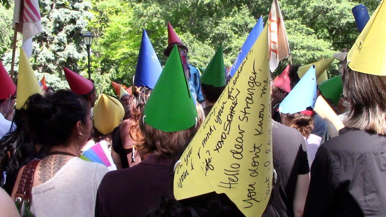Summer of Ludd festival goers wearing paper hats.