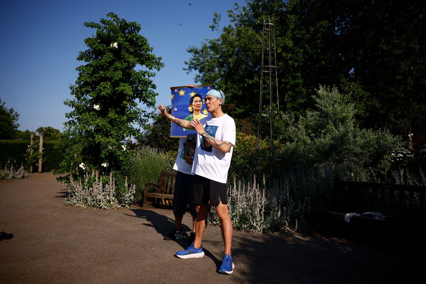 Kim Aris, son of Aung San Suu Kyi, speaks to supporters before taking part in a run on his mother's 80th birthday, to raise awareness of her ongoing incarceration, in Hyde Park in London on June 19, 2025.