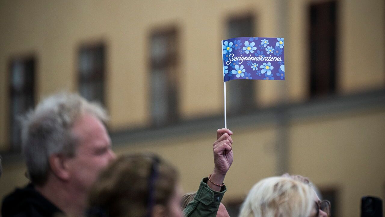 Supporters of the Sweden Democrats wave with flags during an election rally in 2022