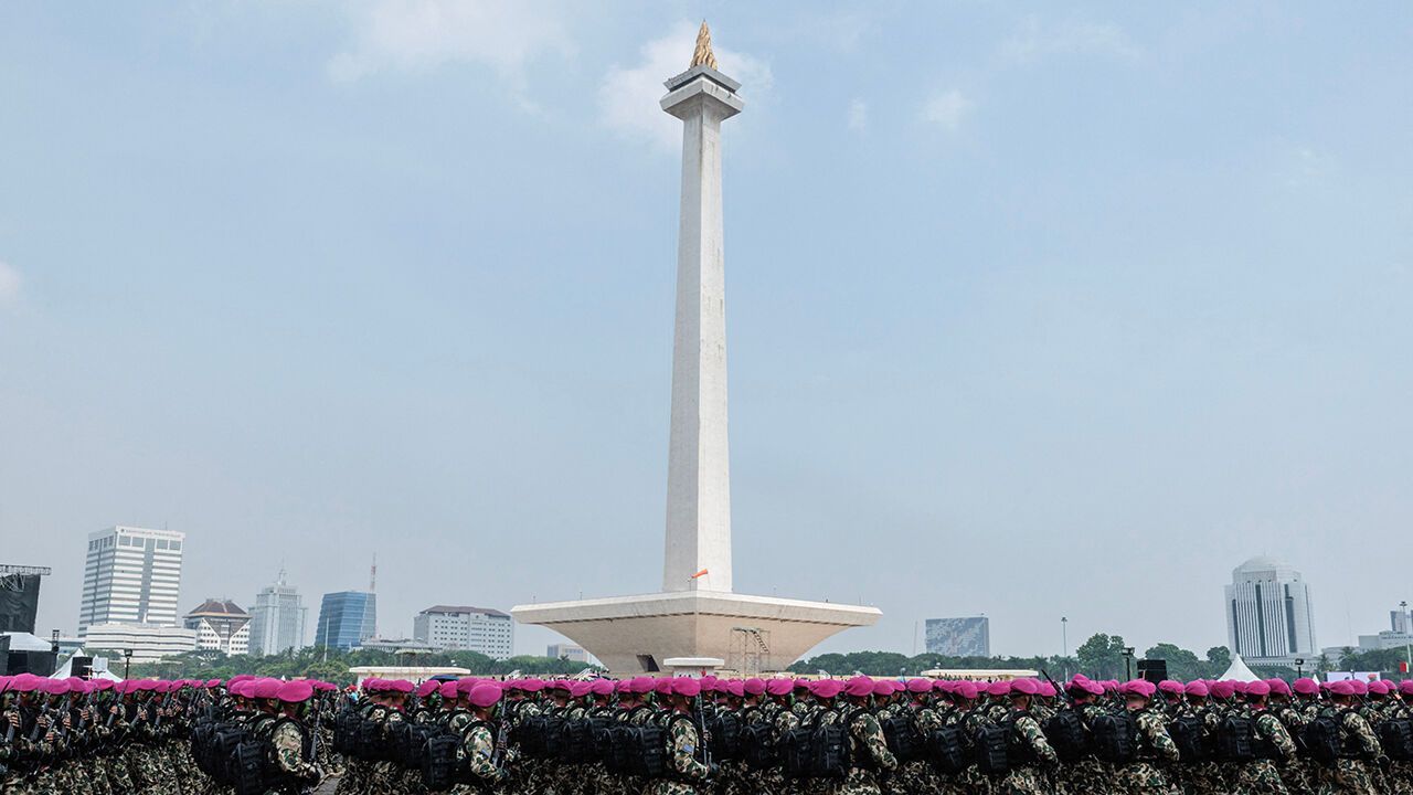 Soldiers march as they take part in a military parade during celebrations marking the 79th anniversary of the Indonesian Armed Forces (TNI) in front of the National Monument (MONAS) at Merdeka Square in Jakarta on October 5, 2024.