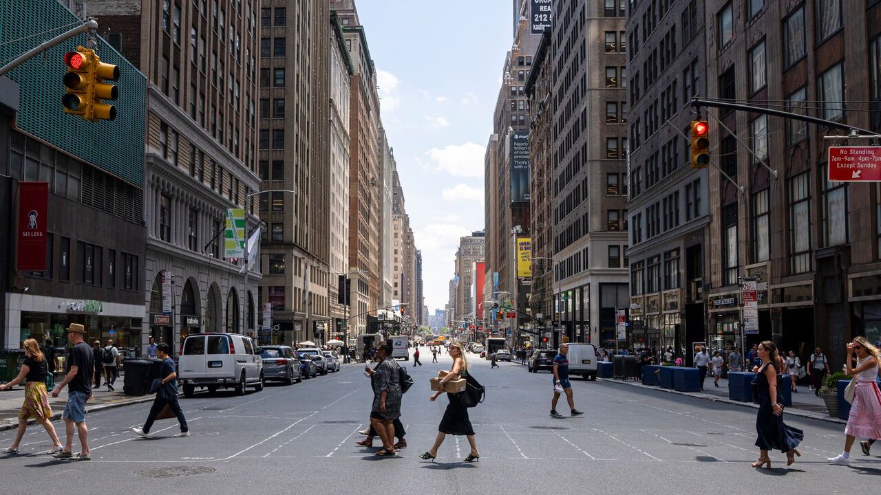 People cross 38th Street and 7th Avenue in Manhattan during a heat wave.