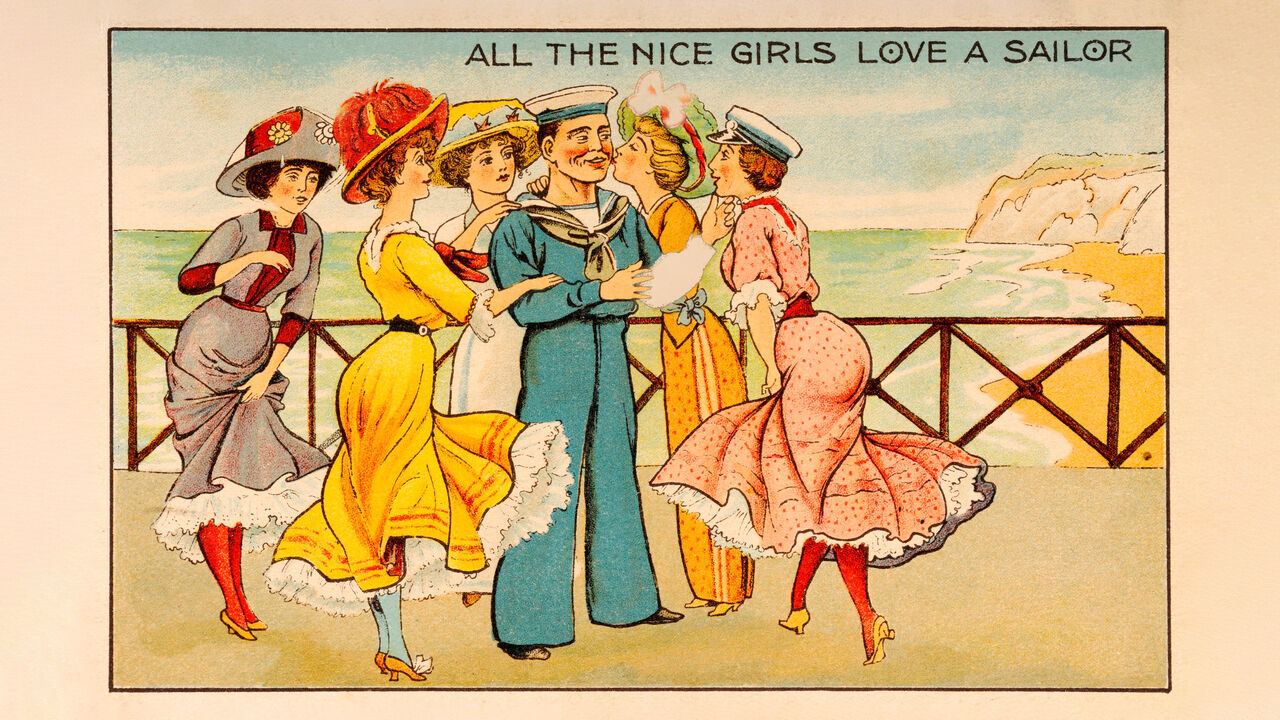 A vintage postcard illustration featuring a group of stylish young women flirting with a sailor at the seaside, circa 1910. The postcard reads 'All the nice girls love a sailor'.