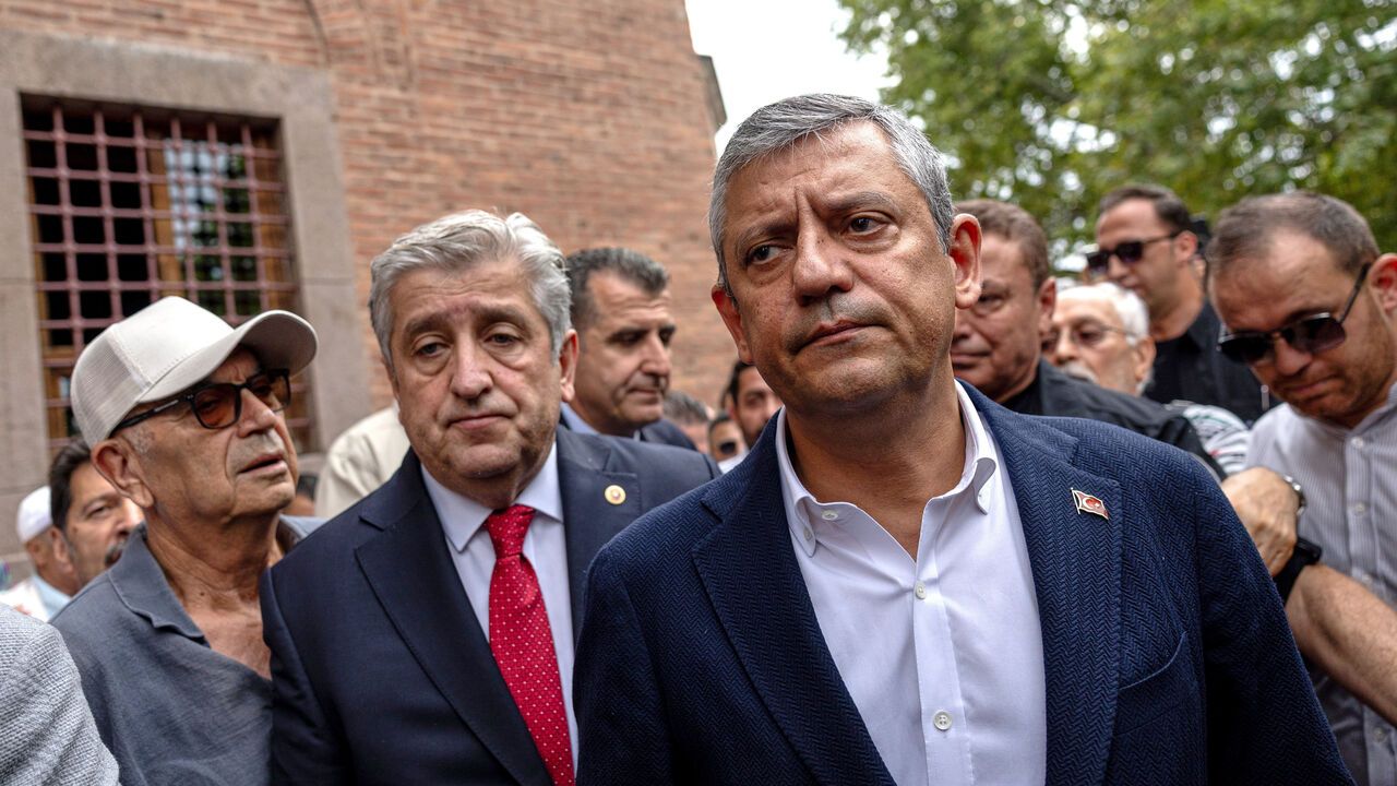 Ozgur Ozel, right, meets supporters after submitting a registration petition to create a new party.