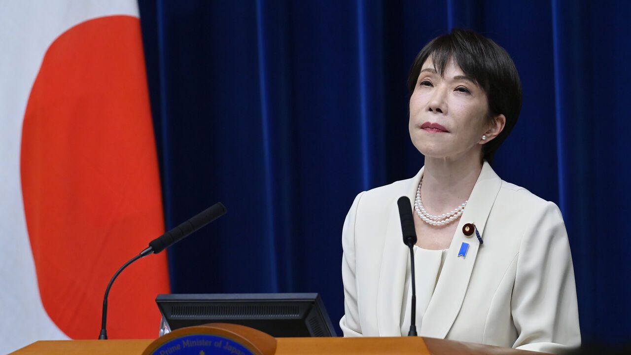 Japanese Prime Minister Sanae Takaichi looks on as she holds a press conference.