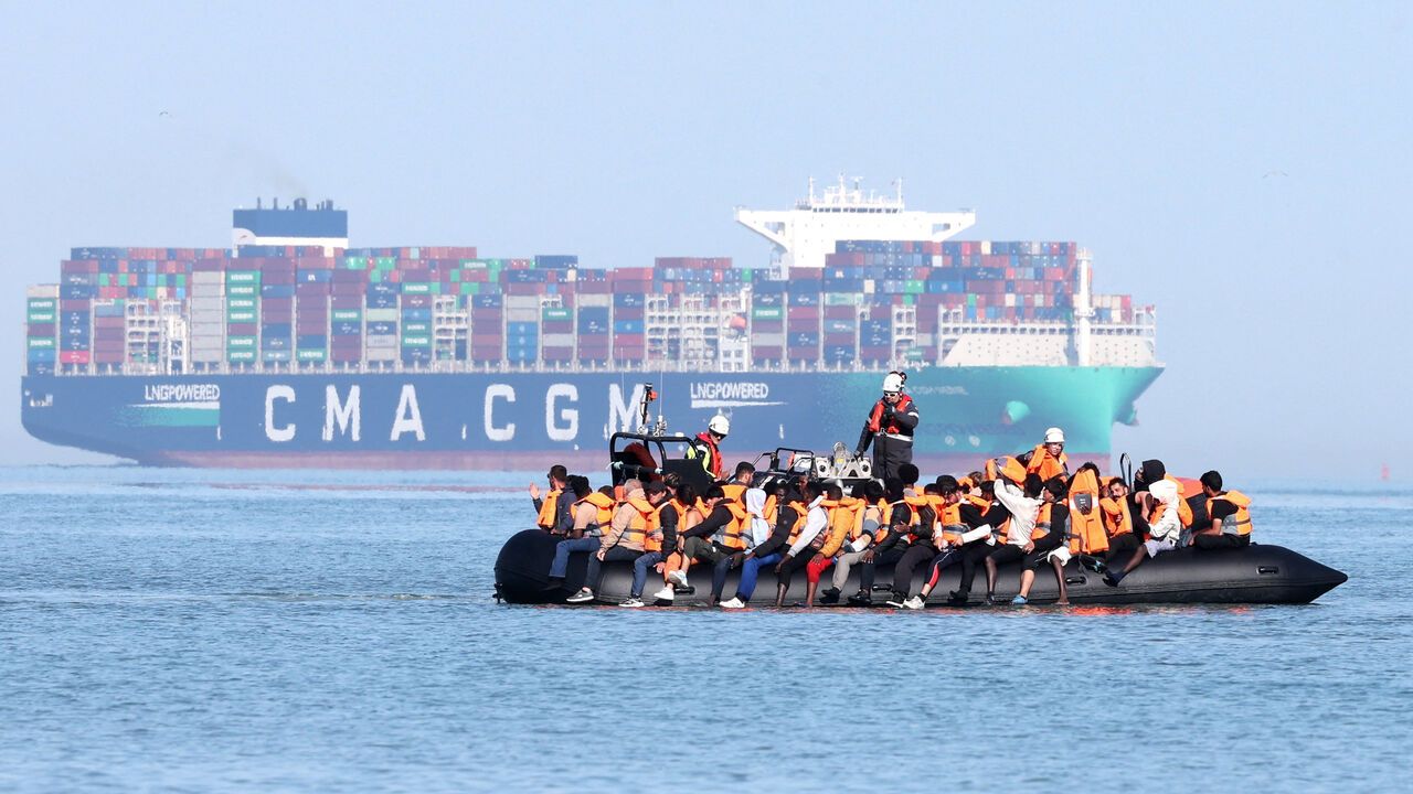 Migrants aboard a smugglers' boat attempt to cross the English Channel off the beach of Gravelines, northern France.
