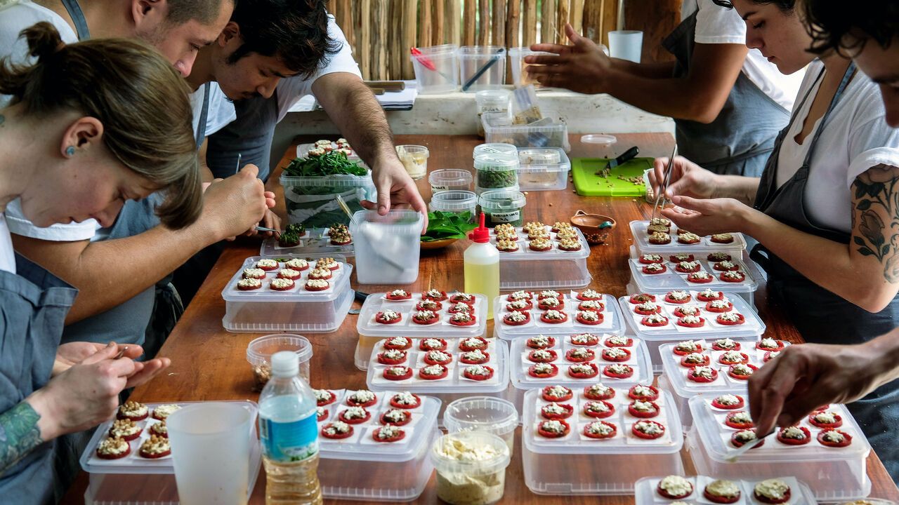 Staff members work on salbute with dried tomatoes and chapulines (grasshoppers) at Noma, Danish Chef Rene Redzepi's pop up, open air restaurant in Tulum, Mexico.