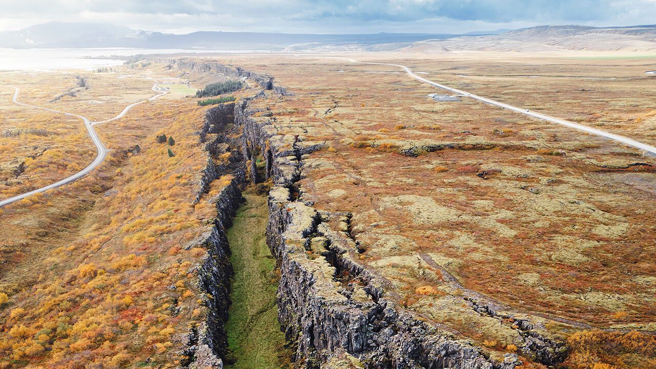 Two tectonic plates meeting on the surface of Earth in a long straight line in Thingvellir National Park.