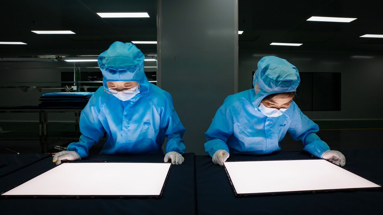 Employees work on the production line of the 15.6-inch portable AI monitors at a workshop of GEN Electronics in a Pan-Semiconductor Industrial Park.
