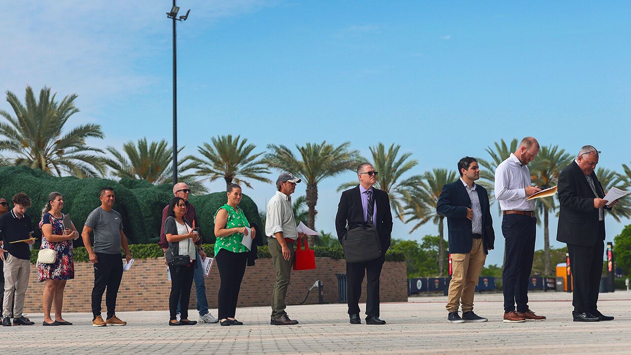 Job seekers wait in line to enter the Mega JobNewsUSA South Florida Job Fair.
