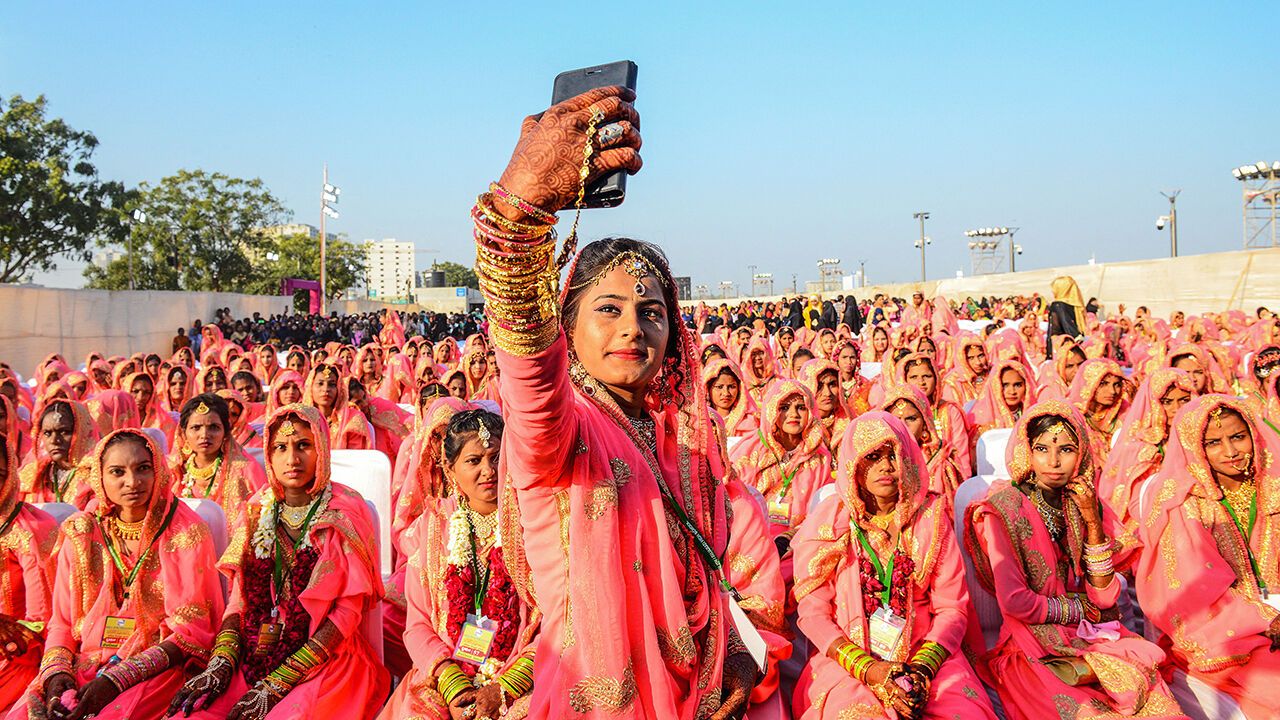 A Muslim bride takes a selfie with her mobile phone as she participates in an 'All Religion Mass Wedding' ceremony at Sabarmati Riverfront in Ahmedabad on February 8, 2020.